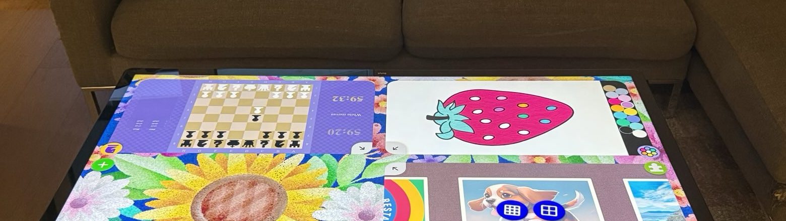 Smart table showing chess, colouring and puzzle games side by side