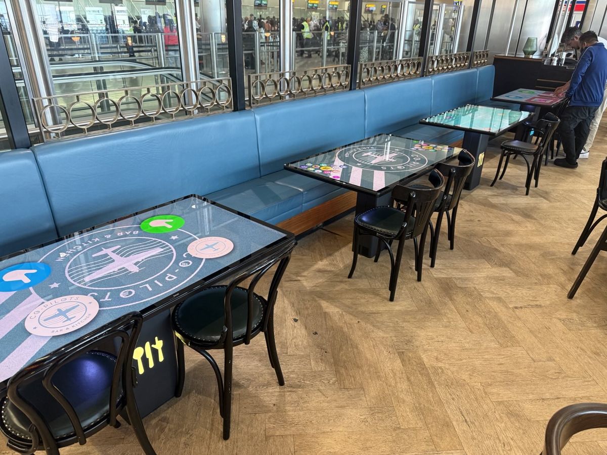 Smart tables in an airport bar beside the departure gates